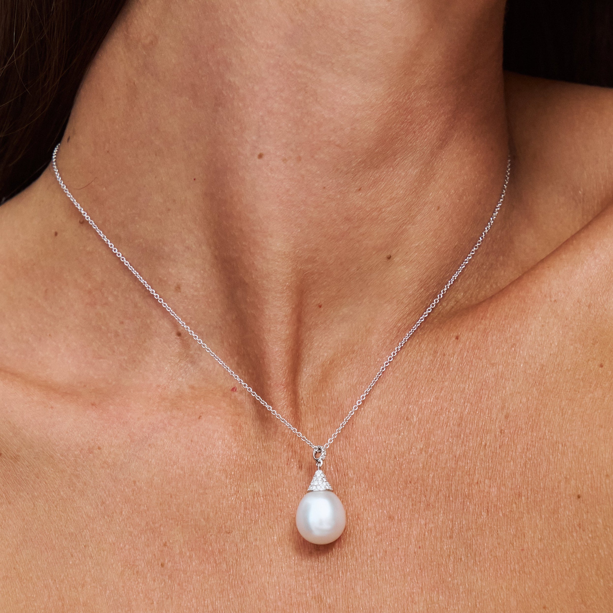 Model wearing Autore South Sea Pearl set in 18kt white gold white diamond pave Luna pendant necklace
