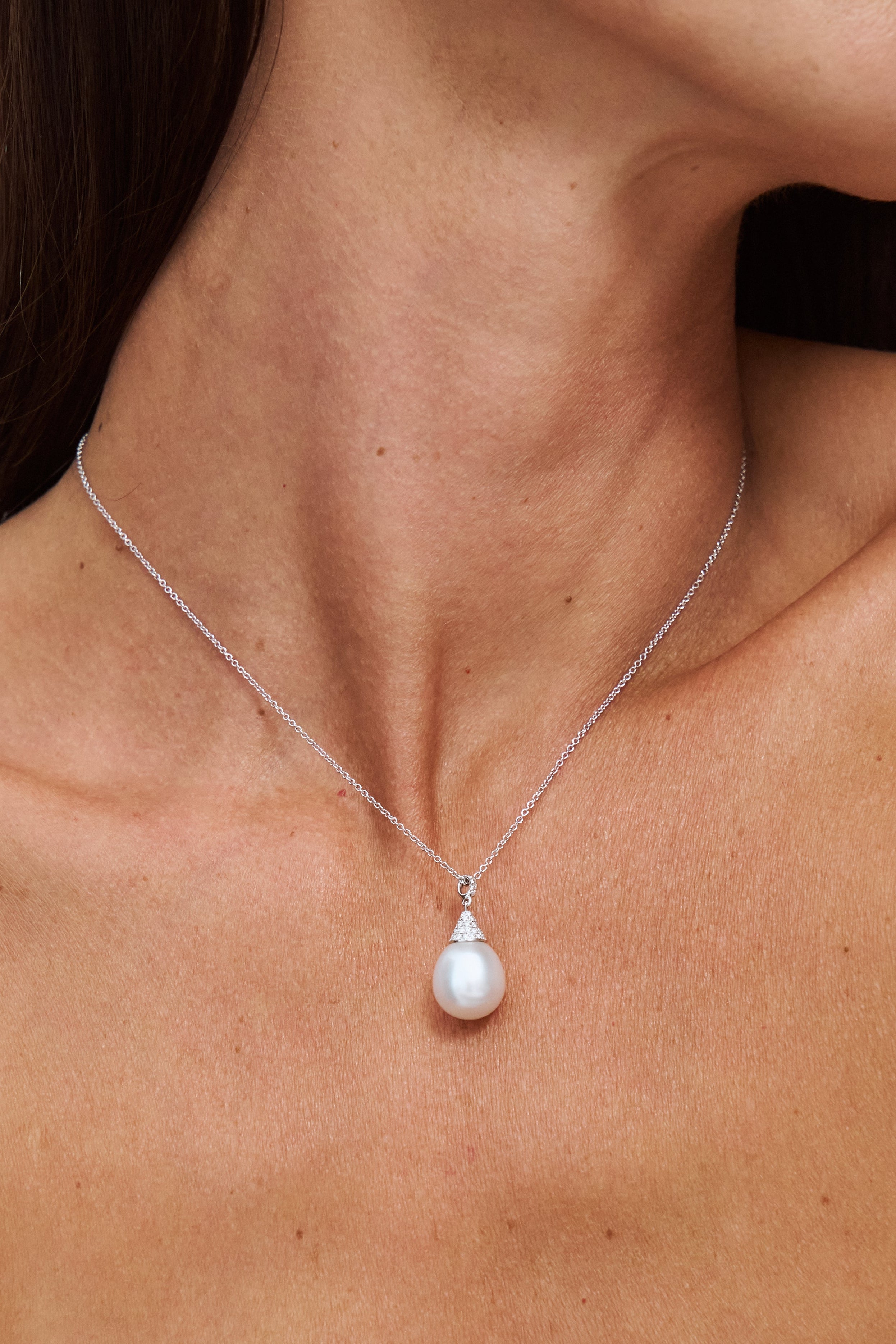 Model wearing Autore South Sea Pearl set in 18kt white gold white diamond pave Luna pendant necklace