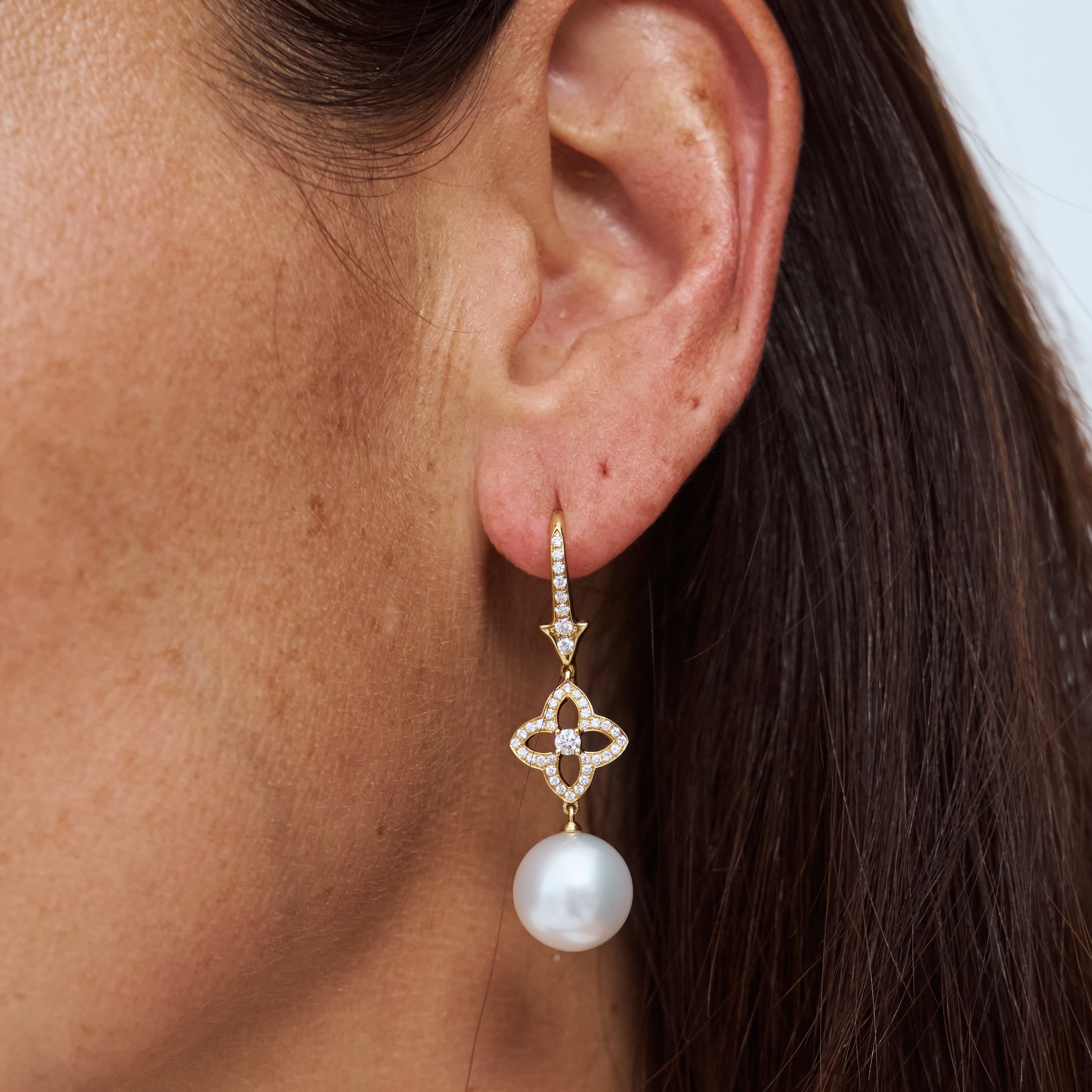 Model wearing Autore South Sea pearl orchid drop earrings in 18kt rose gold with pink diamonds
