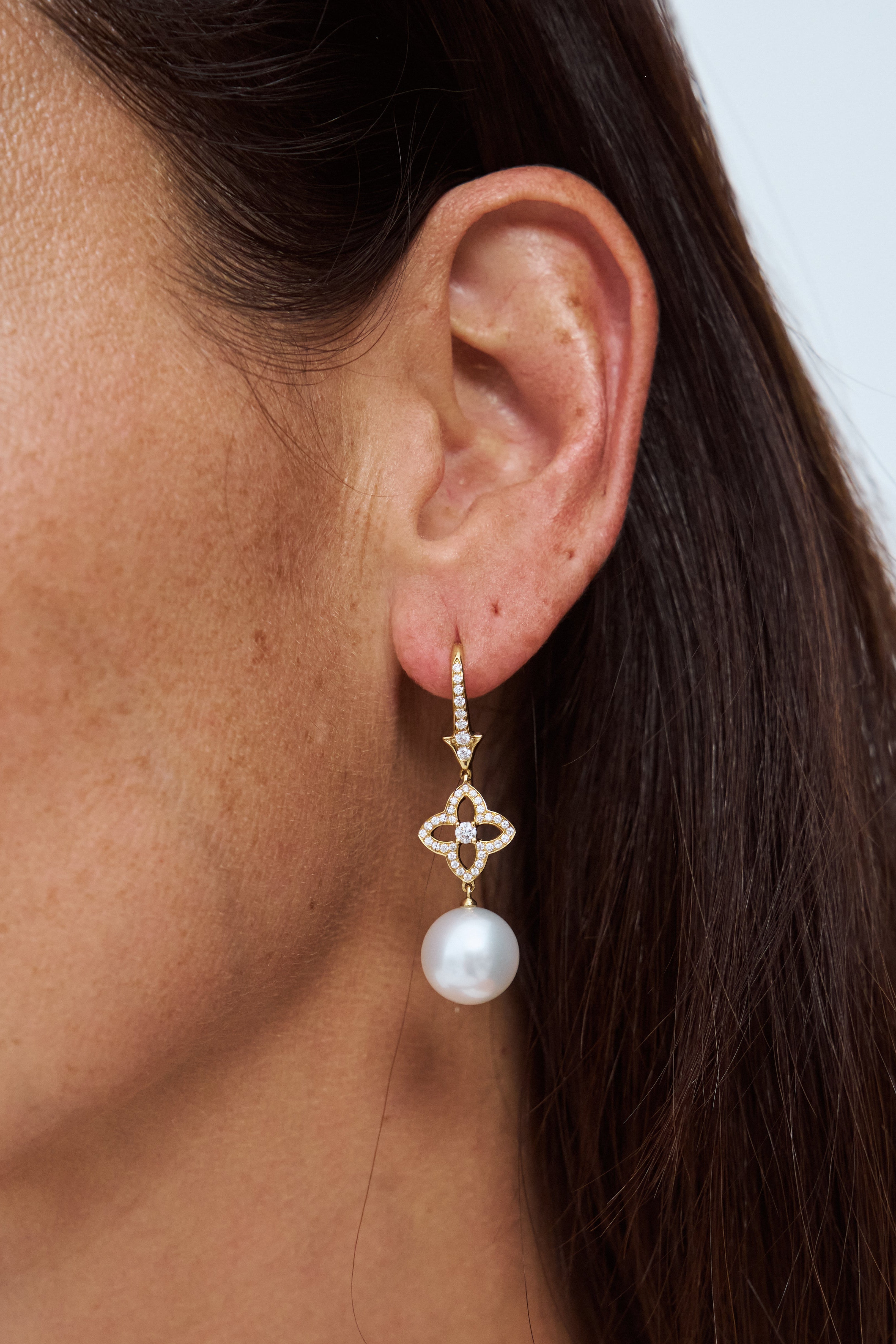 Model wearing Autore South Sea pearl orchid drop earrings in 18kt rose gold with pink diamonds
