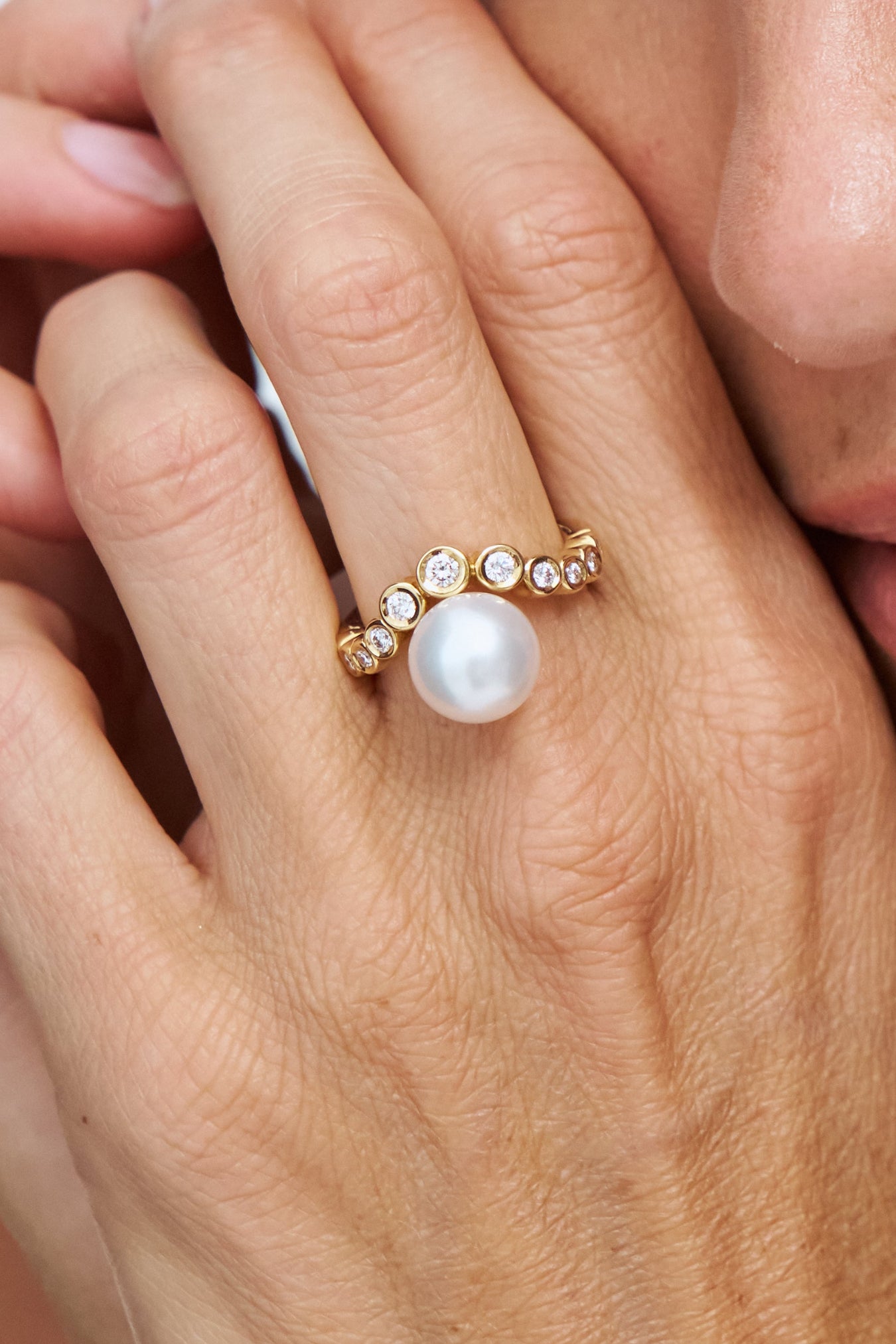 Model wearing the Autore South Sea Pearl Bezel Wave Ring in 18kt yellow gold