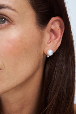 Close-up of model wearing an Autore South Sea Pearl set with white diamond and 18kt white gold stud earring.