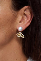 Close up of model wearing Papillion Two Wing Pearl Post Earring featuring Autore South Sea Pearl