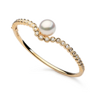 Autore Bezel Wave Bangle featuring white diamonds and Australian South Sea Pearls in 18kt yellow gold