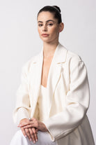 Model wearing a white blazer with the Autore South Sea pearl, ruby and diamond ring in 18kt white gold