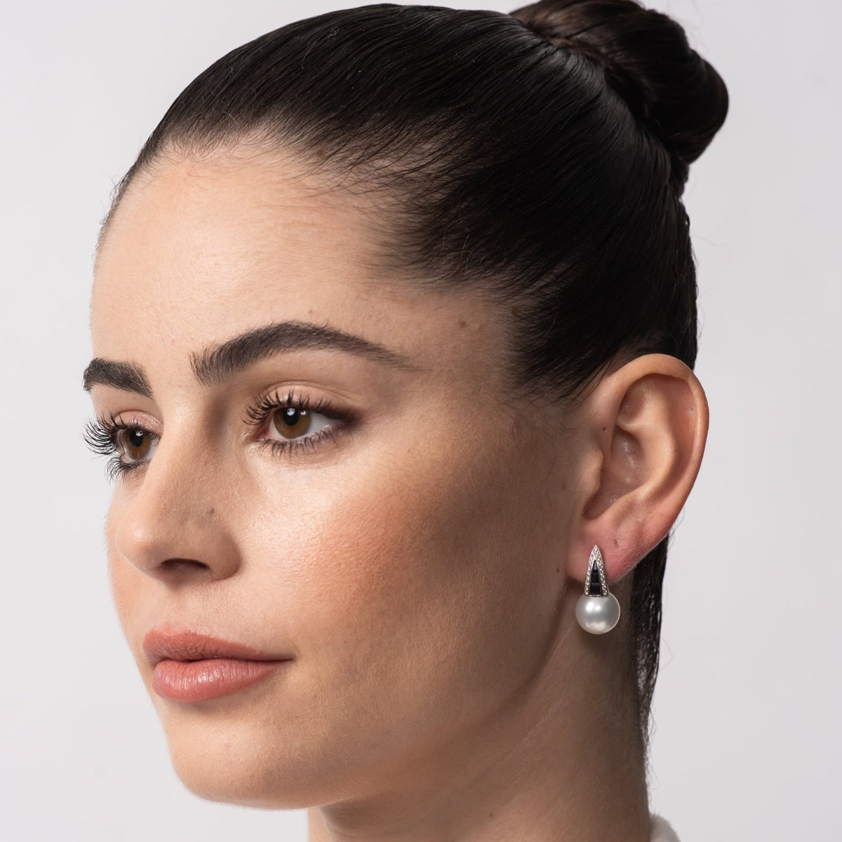 Autore Deco Huggie Earring in Blue Sapphire Australian South Sea Pearl on model